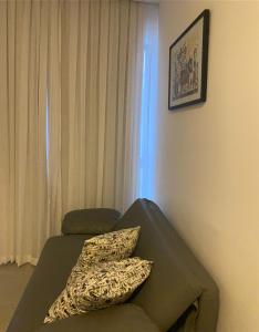a bedroom with a couch with two pillows on it at Estrela Do Mar flat Beach in Porto De Galinhas +10 photos