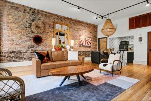a living room with a brick wall at Luxe 220 Suite 7 - Entire in Wilmington