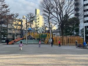 a group of children walking around a playground at Private Room near Iriya in Tokyo