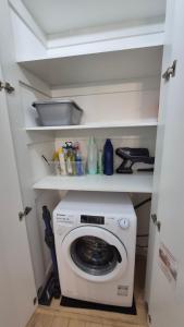 a small kitchen with a washing machine in a room at Apartment Ultra-Central, Parcare, AC, Jaluzele, WiFi in Baia Mare