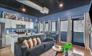 a living room with a couch and a kitchen at New Studio- 2 beds 7 mins to DT in Nashville