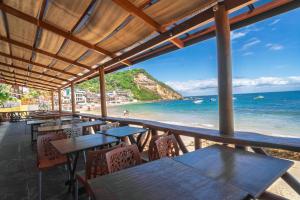 a view of the beach from a restaurant with tables and chairs at Pousada Porto 23 in Morro de São Paulo
