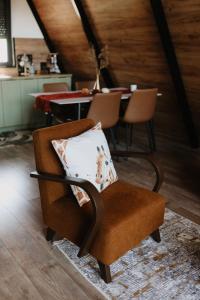 a chair with a pillow in a room with a table at Villa Natura in Bosanska Gradiška