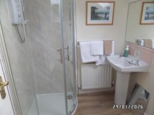 a bathroom with a shower and a sink at Dromard House in Enniskillen