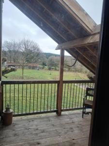 a screened porch with a view of a field at Charme en pleine nature in Thauron