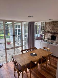 a living room with a wooden table and chairs at Bronte Cottage in Lawson