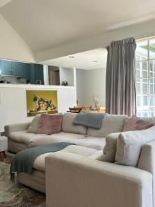 a living room with two couches and a table at Bronte Cottage in Lawson +30 photos