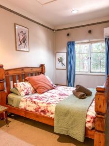 a bedroom with two beds and a window at Bronte Cottage in Lawson