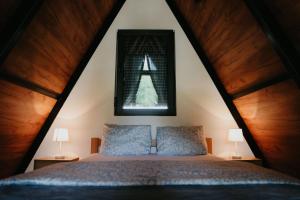 a bedroom with a king sized bed in a attic at Villa Šašava in Bosanska Gradiška