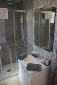 a bathroom with a shower and a sink and a mirror at Hostal Don Peque in Nerja