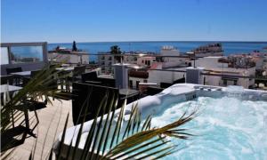a hot tub on the roof of a building at Hostal Don Peque in Nerja