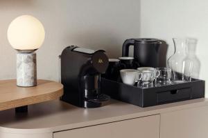 a black coffee maker sitting on top of a counter at Courtyard by Marriott Pilsen in Pilsen +45 photos