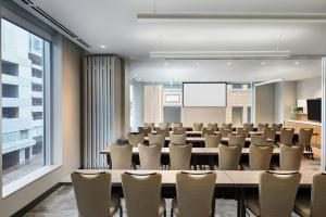 a conference room with a large table and chairs at Aloft by Marriott Austin Downtown in Austin