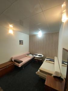 a room with two beds and a table in it at МотельХаусSous in Svitlovodsʼk
