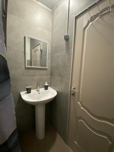a bathroom with a sink and a mirror and a shower at МотельХаусSous in Svitlovodsʼk +3 photos