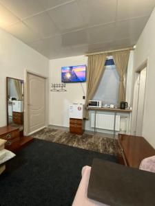 a living room with a couch and a window at МотельХаусSous in Svitlovodsʼk