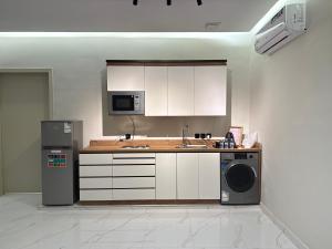 a kitchen with a sink and a dishwasher at نسيم العلا - Naseem AlUla in Al-ʿUla