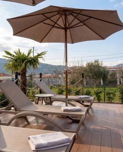 a patio with two chairs and an umbrella at Luxury Villa Bar in Bar