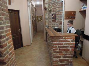 a young boy sitting at a bar in a restaurant at TsisaR Bankir Hotel in Lviv