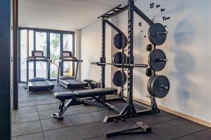 a gym with several weight machines in a room at Kombo Oasis in Serekunda