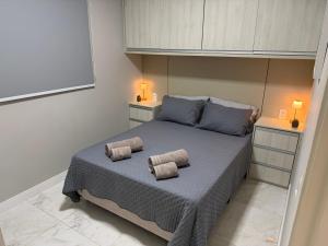 a bedroom with a bed with two pillows on it at Recanto das Colinas II in Espirito Santo Do Pinhal