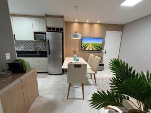 a kitchen and living room with a table and a dining room at Recanto das Colinas II in Espirito Santo Do Pinhal +13 photos