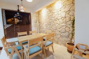 a dining room with a wooden table and chairs and a stone wall at Bernardino Boutique Hotel in Guanajuato +94 photos