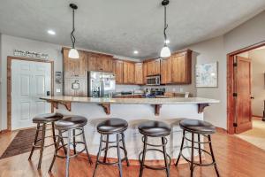 a kitchen with a large counter with stools in it at Bridges Bay Resort Coronado building 200 in Arnolds Park +29 photos