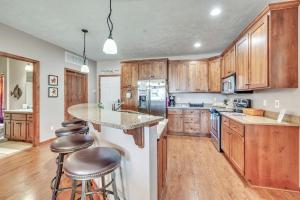 a kitchen with wooden cabinets and a island with bar stools at Bridges Bay Resort Coronado building 200 in Arnolds Park