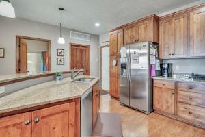 a kitchen with wooden cabinets and a stainless steel refrigerator at Bridges Bay Resort Coronado building 200 in Arnolds Park
