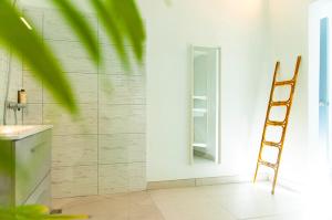 a bathroom with a ladder next to a mirror at Hostal España in Arrecife +33 photos