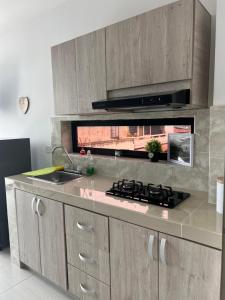 a kitchen with a sink and a stove top oven at Edificio Buenos Aires apartamento 304 moderno Sincelejo in Sincelejo