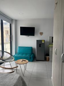a living room with a blue couch and a table at Edificio Buenos Aires apartamento 304 moderno Sincelejo in Sincelejo +3 photos