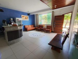 a living room with a couch and a fireplace at Pousada Tropical in Prado