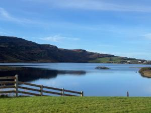 a view of a lake with a wooden fence at Sessaigh lake studio in Dunfanaghy