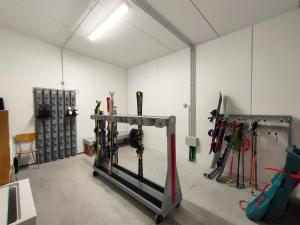 a room with skis and ski equipment in it at Appartamenti La Val in Andalo