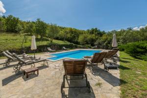 a group of chairs and a swimming pool at Villa Boljuncica in Boljun