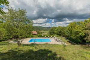 a swimming pool in a field with lounge chairs at Villa Boljuncica in Boljun +39 photos