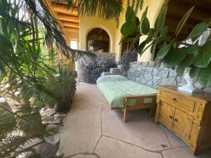 a patio with a bench and a stone wall at "Crows Nest" at Winsor Castle in Valdez