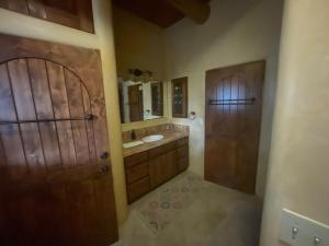 a bathroom with a wooden door and a sink at "Crows Nest" at Winsor Castle in Valdez +119 photos