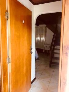 an open door to a hallway with a staircase at Pousada Pinho Verde in Monte Verde