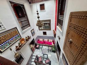 an overhead view of a living room with pink furniture at Dar Karaouyine Panoramic in Fez