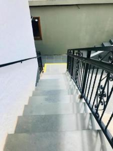 a staircase in a building with a black railing at Pousada Pinho Verde in Monte Verde