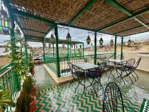 a group of tables and chairs on a patio at Dar Karaouyine Panoramic in Fez