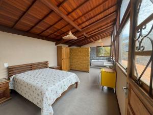 a bedroom with a bed and a bathroom with a tub at CASA VENTO SOLAR in Santana do Riacho