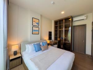 a bedroom with a large white bed with blue pillows at Lovely 2 Bdr Canvas BangTao in Laguna Phuket +26 photos