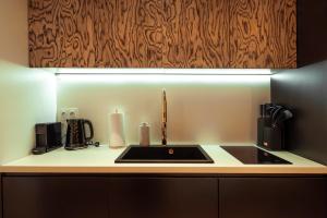 a kitchen with a sink with a light above it at Gdańsk Luxury Stay Jacuzzi in Gdańsk +21 photos