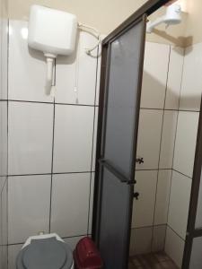 a bathroom with a toilet and a dispenser on the wall at Ada 507 avenida pioneros del este in Ciudad del Este
