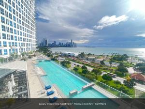 an overhead view of a swimming pool in a city at 80M Luxury Ocean View Apartment PH The Sands, Next to Hilton in Panama City