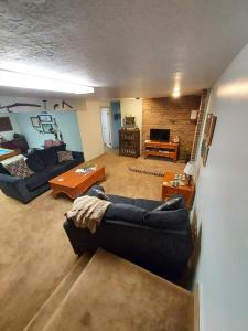 a living room with two couches and a table at Beautiful Country Location in Harrisville